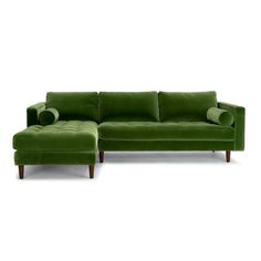 a green couch and footstool sitting next to each other on a white background