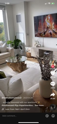 a living room filled with furniture and a flat screen tv mounted to the side of a wall