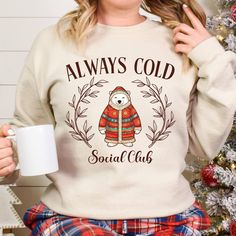 This ALWAYS COLD SOCIAL CLUB sweatshirt with its funny polar bear is the perfect warm crewneck for any women who is always freezing in the winter. Get this cozy sweatshirt for yourself or give it as a gift to your freezing friend.  It makes the perfect gift for any fall or winter birthday. This ALWAYS COLD SOCIAL CLUB sweatshirt with its funny polar bear is the perfect novelty gift for anyone who is freezing all winter long. This funny sweatshirt makes the perfect gift for any women this fall or Winter Cotton Top With Bear Print, Winter Bear Print Cotton Top, Winter Crewneck, Always Cold, Club Sweatshirts, Winter Birthday, Winter Sweatshirt, Funny Sweatshirts, Social Club