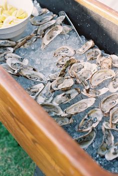 oysters are being prepared on ice in an outdoor grill