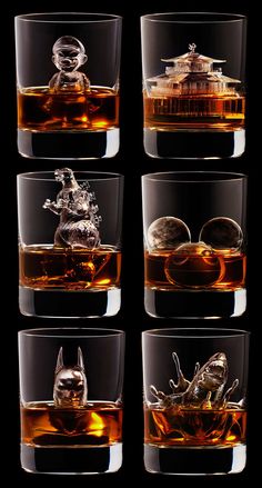 four glasses filled with different types of liquor and some sort of animal figurine