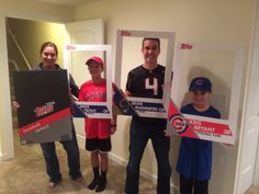 four people holding up signs in front of a doorway with the number 4 on them