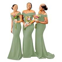 three women in green dresses standing next to each other with bouquets on their chests