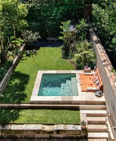 an aerial view of a small backyard with a pool and hot tub in the middle