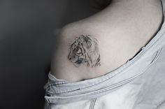 a woman with a tiger tattoo on her shoulder