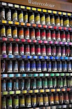 an assortment of different colors of watercolors on display in a store or office