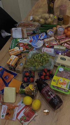 a wooden table topped with lots of different types of foods and condiments on top of it