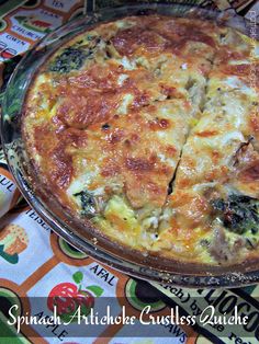 a quiche with cheese and spinach on a colorful tablecloth is ready to be eaten