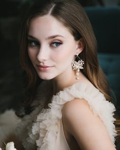 a woman in a white dress holding a flower