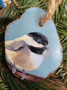 a bird ornament hanging from a christmas tree