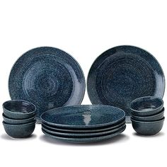 a stack of blue plates and bowls sitting next to each other