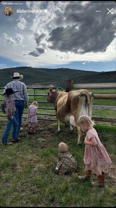 a group of people standing around a cow in a fenced in area with other animals