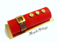 a red leather case with gold buttons on it