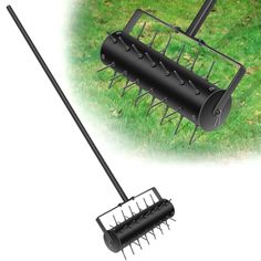 a black garden rake with spikes on the grass