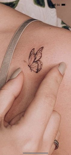 a woman's stomach with a butterfly tattoo on her left side ribcage