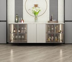 an elegant bar with wine glasses, bottles and flowers on the top shelf in front of it