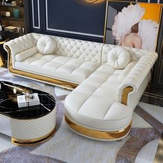 a living room with white couches and gold accents