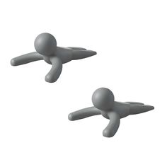 two white plastic figures are flying in the air