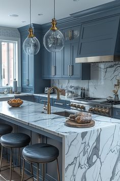 a kitchen with blue cabinets and marble counter tops, an island in the middle is surrounded by stools