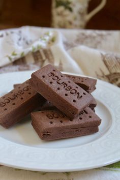 three pieces of chocolate on a white plate