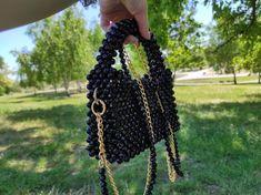 An exclusive handmade beaded bag made of black faceted acrylic beads that shimmers beautifully in the sun. The women's purse has compact dimensions and an elegant design, which is perfect for an evening, formal or festive look. This exclusive bag is woven from black faceted beads that shimmer in the light, has a lining, closes with a magnetic clasp. The bag can be carried in the hand holding the handle or on the shoulder, the set comes with two chains of the same length, which can be worn separa Pearl Bag, Purse Gift, Beaded Bag, Novelty Bags, Beaded Handbag, Luxury Bag, Beaded Bags, Small Wallet, Womens Purses