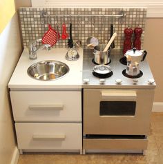 a small kitchen with a sink and stove top oven in it's side by side