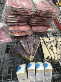 several different types of cheese and meat on display