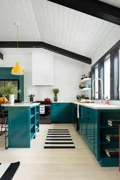 a kitchen with teal cabinets and white counter tops is pictured in this image from the inside