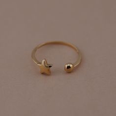 Precious shooting star ring 14K solid gold. This hand-made shooting star ring made to show the imagination of growth. This shooting star ring created to spread the word of love and friendship. The pure 14k gold shooting star ring crafted in Los Angeles. All the orders are coming with complete packaging including box. Approximate weight: 0.9 gram Tehrani Jewelry ▷ Returns & Exchanges we understand how important it is to love what you buy! If for any reason, you are not satisfied with your purchase, we gladly accept returns, exchanges, and cancellations. * Please contact us within 2 weeks. * Ship item(s) back to us within 3 weeks of delivery. * Request a cancellation: within 24 hours of purchase.  -Return accepted in their original conditions with no question asked with in the return policy Dainty Gold Ring, Jewelry Minimal, Star Motif, Dainty Gold Rings, Birthday Ring, Midi Rings, Minimal Jewelry, Gold Piece, Star Ring