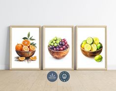 three paintings of fruit are displayed on the wall in front of a wooden floor and white walls