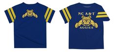 Let your kiddo look cool in his new team spirit boys tee shirt. Let him play, go to the game, and cheer loudly and proudly with his NC A&T North Carolina A&T State University Aggies gear by Vive La Fete. Celebrate and cheer on game day with our classic design NC A&T North Carolina A&T State University Aggies Short Overstitched Crew Neck Sleeve Top. Officially Licensed product sold by Vive La Fete. This awesome graphics, fun and game day crew neck t-shirt features officially licensed NC A&T North Boy Tees, Blue Shorts, Tee Design, Team Spirit, Look Cool, State University, Soft Knits, Game Day, North Carolina