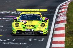 a yellow sports car driving on a race track