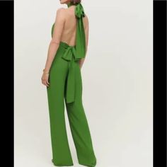 The Roland Is A Sleeveless, Full-Length Jumpsuit With A Halter Neck And Relaxed Legs. It Features An Open Back, Ties At The Neck And Waist, And Front Ruching. Up To 32” Waistline, 33” Inseam, 13” Trouser At Bottom - Fitted Waist - Full Length - Halter Neck - High Rise - Lined - Open Back - Relaxed Fit In Leg - Ruching On Bodice - Ties At Back Neck - Ties At Waist Elegant Green Strapless Jumpsuit, Green Wide-leg Jumpsuits For Party, Green Wide Leg Jumpsuits And Rompers For Party, Green Wide Leg Jumpsuits For Party, Elegant Green Strapless Jumpsuit For Night Out, Green Strapless Sleeveless Jumpsuit For Spring, Green Sleeveless Jumpsuits And Rompers For Evening, Green Sleeveless Jumpsuits For Evening, Green Summer Evening Jumpsuits And Rompers