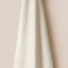 a white towel hanging on the wall