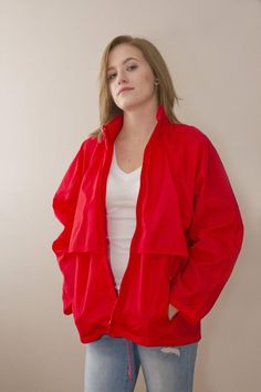 This is a retro Eddie Bauer Wind breaker 100% Nylon. Bright red in colour with mess lining inside covering the venting. There is a hood that can be tucked and zipped away if you prefer not to use it. The bottom has pull ties to make it more fitted. Front Pockets are zip.Measurements:Shoulder to Hem  27"Bottom Circumference(at Hip) 44"Sleeve length 28"Size listed Women's MModel is a size 8Great vintage condition Red Hooded Nylon Windbreaker, Red Nylon Track Jacket For Outdoor, Red Long Sleeve Nylon Windbreaker, Red Retro Track Jacket For Outdoor, Retro Red Track Jacket For Outdoor, Red Nylon Outerwear With Pockets, Retro Red Hooded Windbreaker, Red Retro Windbreaker With Pockets, Red Retro Hooded Windbreaker