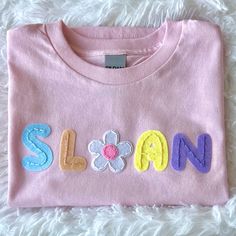 a pink shirt that says sloan on it