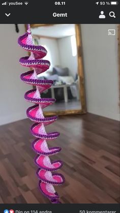 a pink and purple spiral decoration in front of a mirror