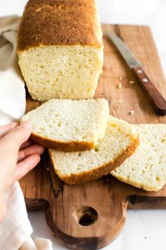 sliced loaf of white bread sitting on top of a cutting board