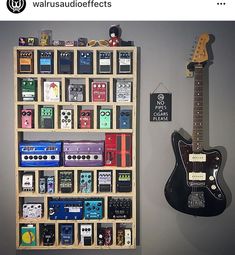 there is a guitar and many other items on the wall next to eachother