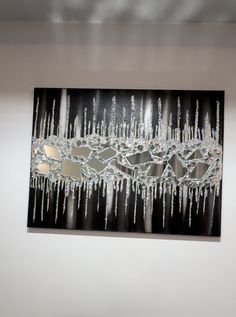 a chandelier hanging from the ceiling in front of a wall with icicles on it