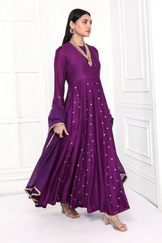 Deep purple chanderi flared anarkali with full sleeves, floral sequin and bead embroidery. Paired with mukaish work dupatta with kiran lace border.
Components: 2
Pattern: Embroidered
Type Of Work: Floral Sequin, Bead, Mukaish and Gota Work
Neckline: Round Neck
Sleeve Type: Full Sleeves
Fabric: Chanderi
Color: Purple
Other Details: 
Attached lining
Panelled flare
Loop buttons on sleeves
Model Height: 5ft 11inches, wearing size S
Anarkali Length: 53 inches
Approx. product weight: 0.85 kgs
Closure: Elegant Purple Anarkali Set For Festivals, Eid Long Sleeve Dress With Mirror Work, Festive Long Sleeve Churidar With Mirror Work, Elegant Purple Anarkali Set For Festive Occasions, Bollywood Style Long Sleeve Dress With Mirror Work, Bollywood Long Sleeve Dress With Mirror Work, Long Sleeve Dresses With Mirror Work For Eid, Purple Long Sleeve Churidar For Party, Designer Long Sleeve Churidar With Dabka Work