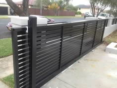 a car is parked in front of a fence