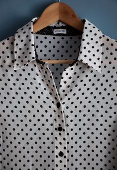 Vintage women's black and white polka dot print blouse, from the 1990s Short sleeve, buttoned blouse with a collar and a black polka dot print on a white background, which on the bottom is contrasted by a white polka dot print on a black background in two differed sizes of the dots. The sleeves have side slits 100% viscose, slightly transparent fabric Size - marked 22 DE , this is the German sizing for shorter women (< 164 cm), corresponds to 44 DE or XL. If you are taller than that, please l Polka Dot Blouse Outfit, 90s Pattern, Transparent Fabric, Fashion Jackson, Pattern Blouse, Black And White Polka Dot, Polka Dot Blouse, Blouse Outfit, Womens Blouses