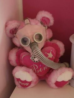 a pink teddy bear wearing a gas mask