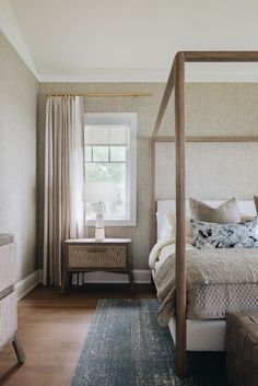 a bed sitting next to a window in a bedroom