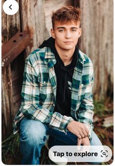 a young man sitting in front of a wooden fence with the caption tap to explore