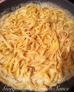 a pan filled with pasta and sauce on top of a stove