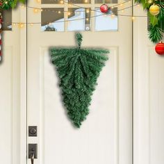 a christmas tree hanging on the front door