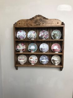 a wooden shelf with many plates on it