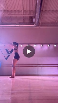 a woman standing on top of a hard wood floor